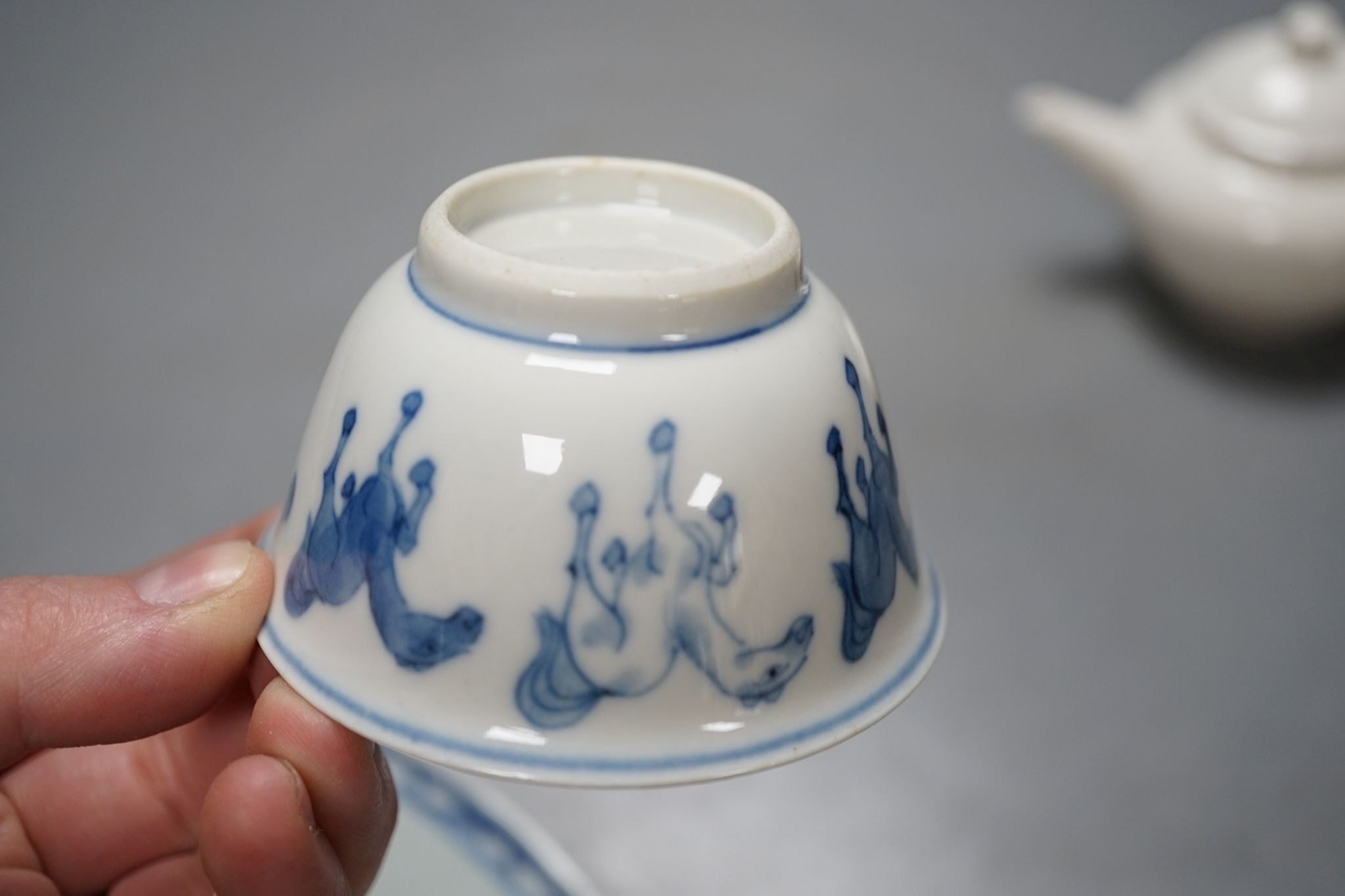 A Chinese blue and white plate, 23.5 cm, a similar tea bowl and saucer, a saucer and a white glaze teapot and cover, 18th century and later